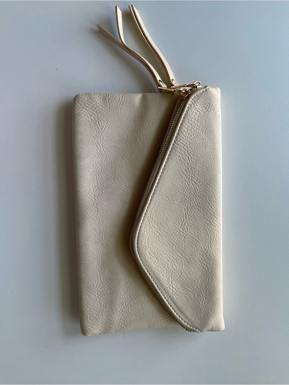 Cream leather clutch with zipper closure